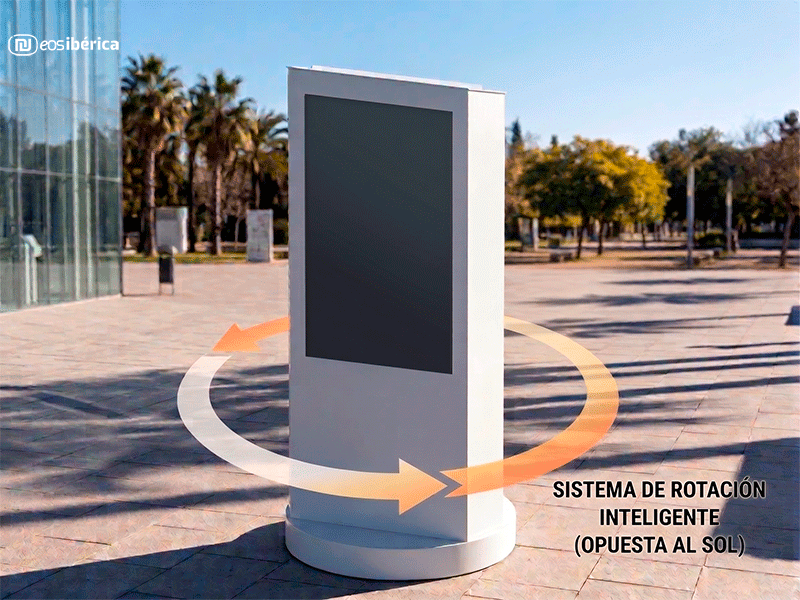 Tótem de exterior inteligente Helios con sistema de rotación para ahorrar energía y frenar el sobrecalentamiento ubicado en una calle luminosa y con árboles